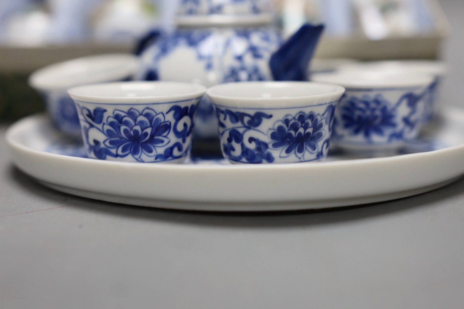 A Chinese blue and white miniature teapot, 6 matching cups and a tray and a box of five vases